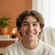 Portrait of a smiling young adult, representing a happy and trusted customer.